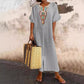 Casual and loose-fitting dress for women, made of cotton and linen with embroidery and a slit.